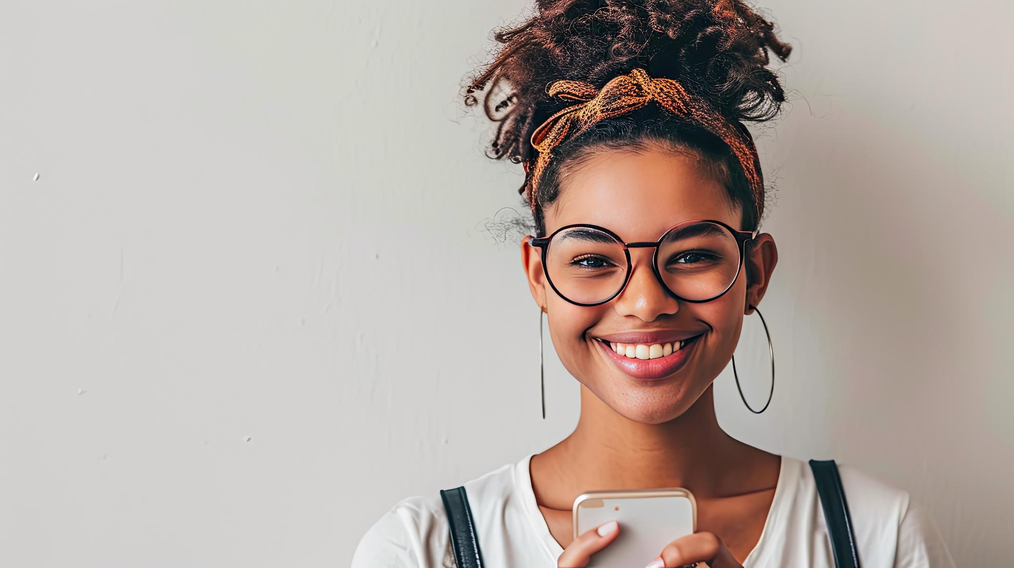 Portrait of young happy woman sending mobile messages on white b